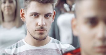 Close-up image of young man wearing a striped shirt. 