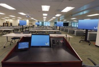 Podium, rows of empty seats, examination room. 