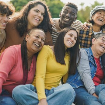 A group of diverse adult persons smiling