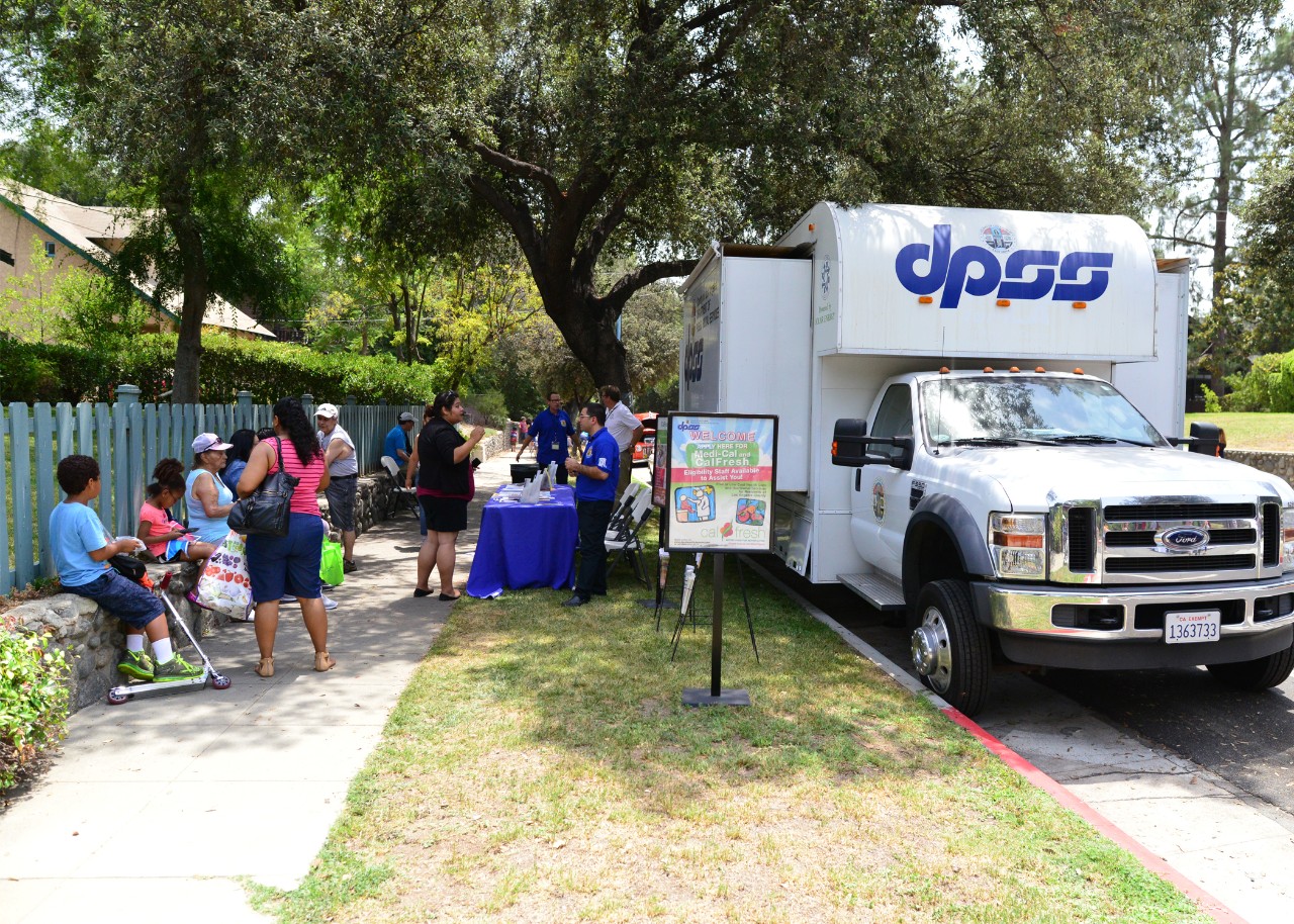 DPSS representatives talk to people about DPSS services. 
