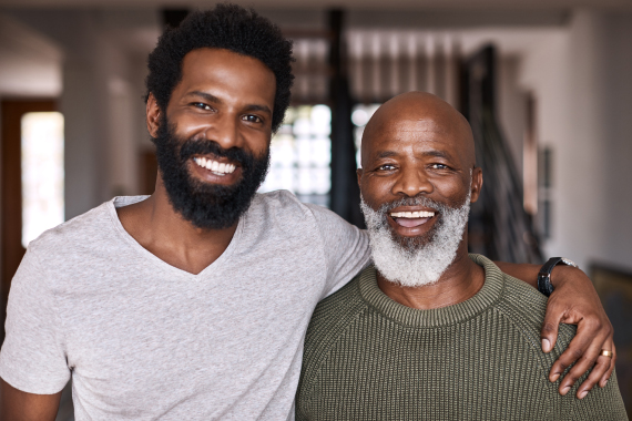 Portrait of a happy young man relaxing and spending time with his father at home